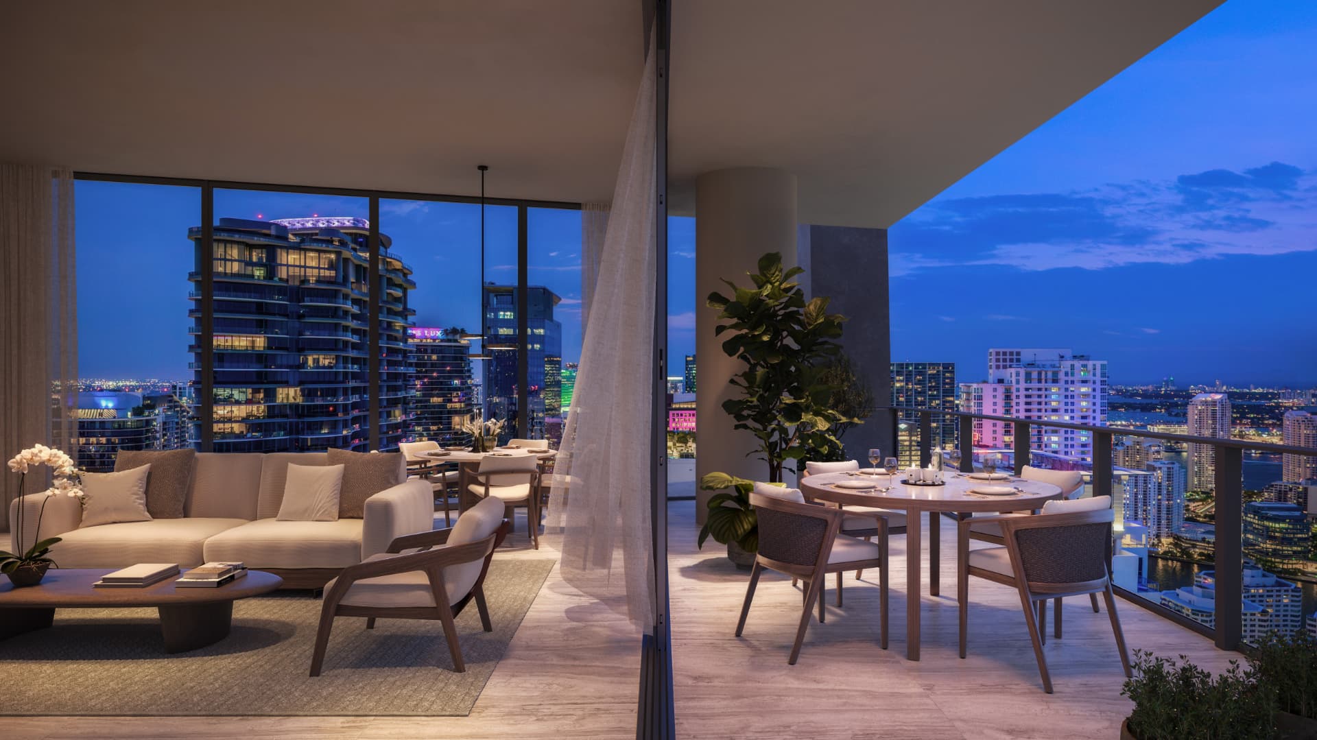 Living integrado à varanda de uma residência do ORA by Casa Tua com vista noturna de Miami